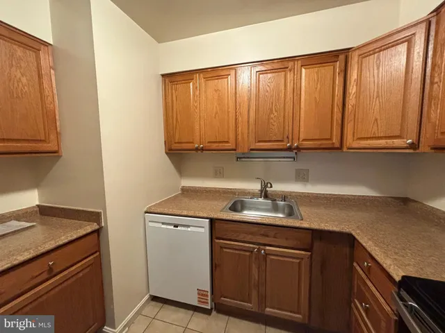 a kitchen with a sink cabinets and window