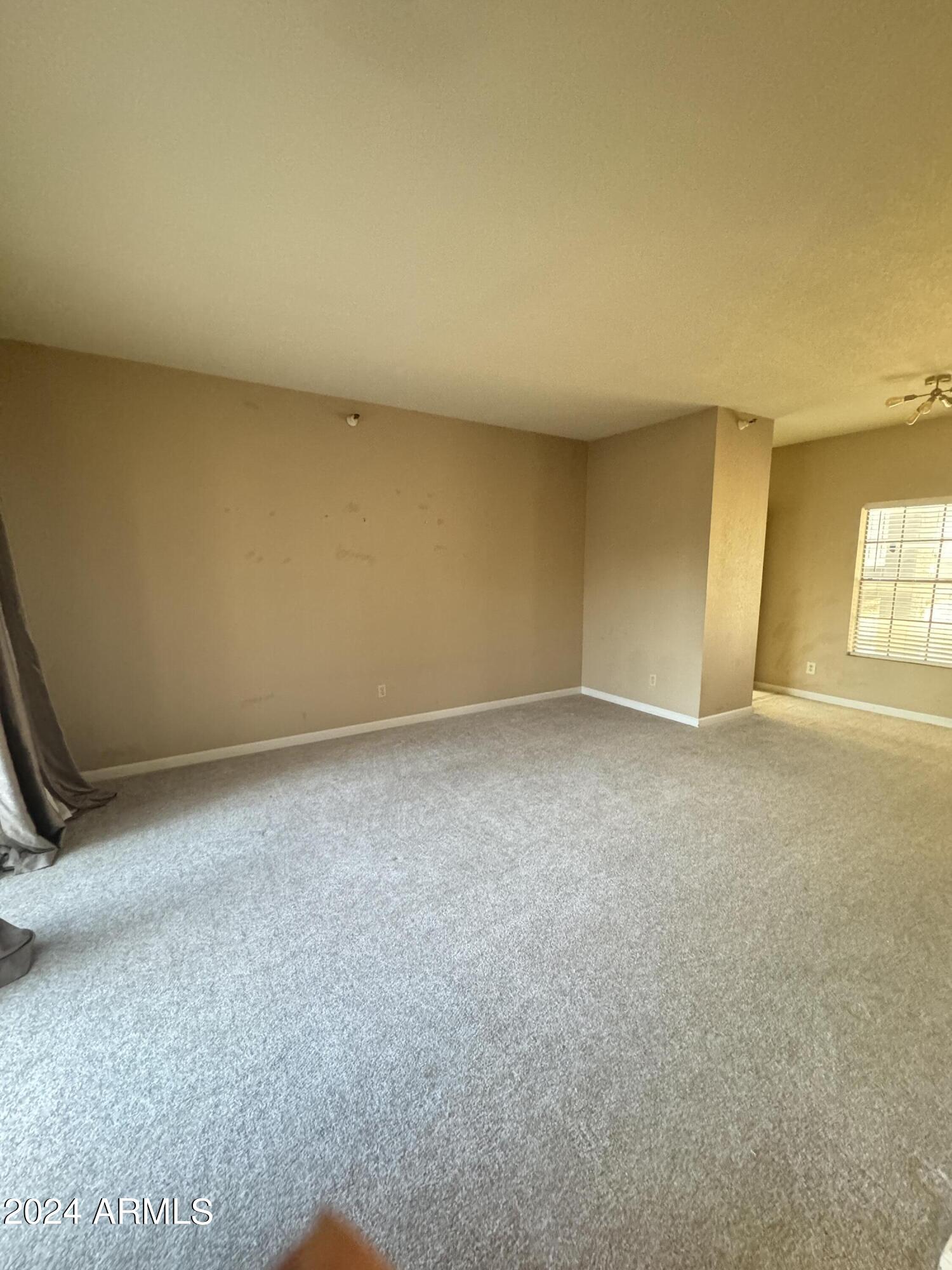 8020 East Thomas Road, Unit 226 Scottsdale, AZ 85251 - Photo 10 of 16 an empty room with windows