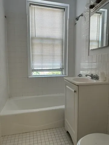 a bathroom with a granite countertop bathtub shower and a sink