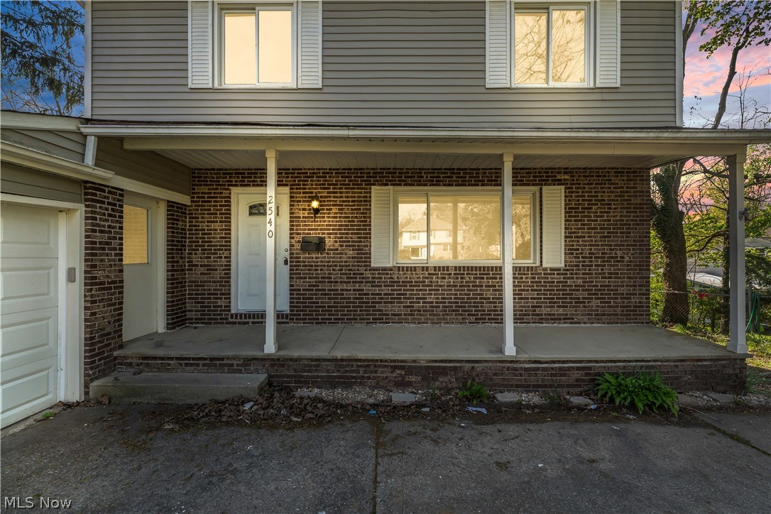 2540 Charney Road University Heights, OH 44118 - Photo 3 of 44 Front exterior with a covered porch featuring brick and siding finishes