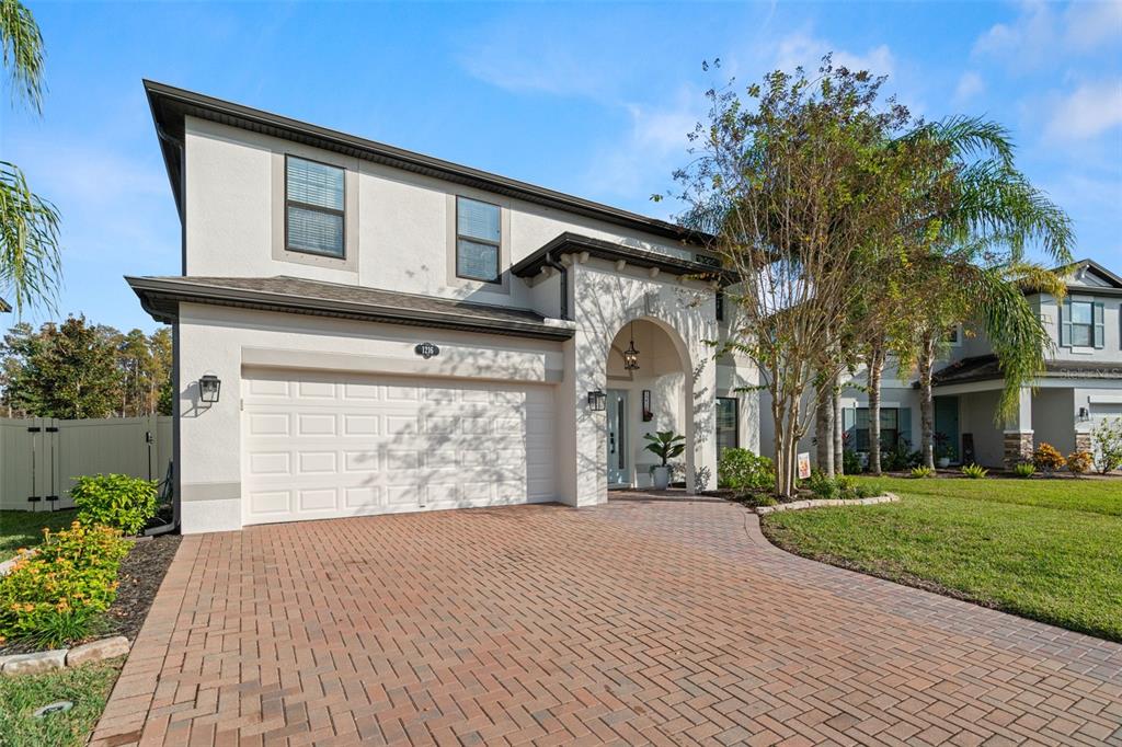 1216 Multiflora Loop Lutz, FL 33558 - Photo 1 of 1 a front view of a house with garden