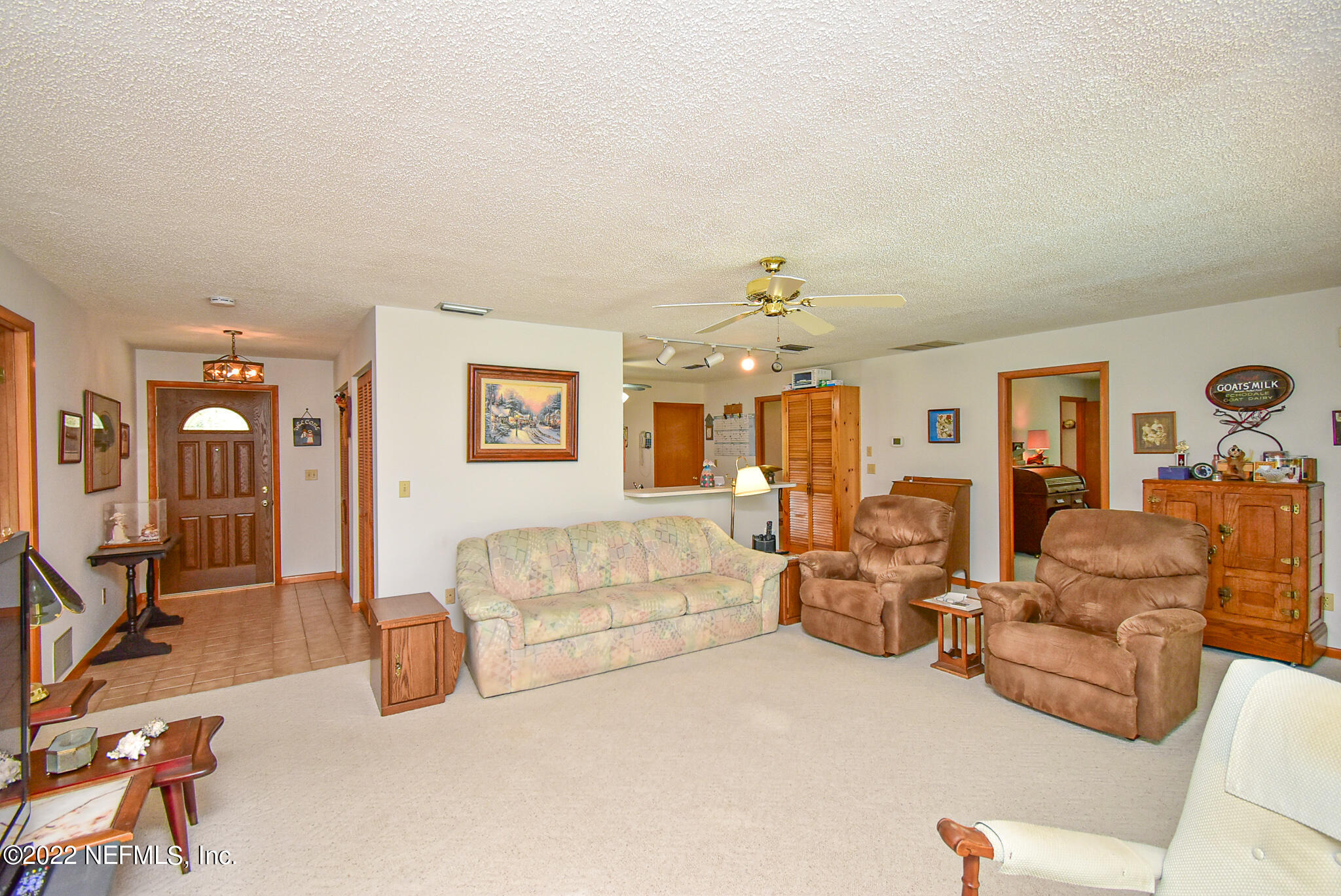105 Tallow Road Pomona Park, FL 32181 - Photo 14 of 55 a living room with furniture and a chandelier