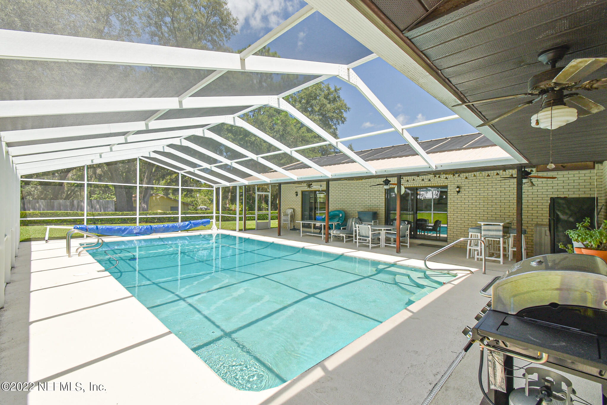 105 Tallow Road Pomona Park, FL 32181 - Photo 16 of 55 a swimming pool with outdoor seating and yard