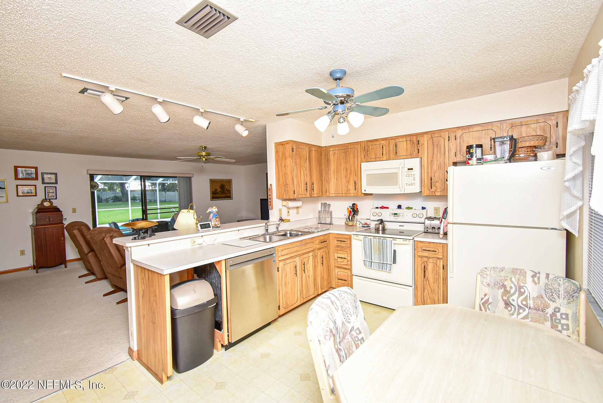 105 Tallow Road Pomona Park, FL 32181 - Photo 22 of 55 a kitchen with a stove a refrigerator and a fireplace