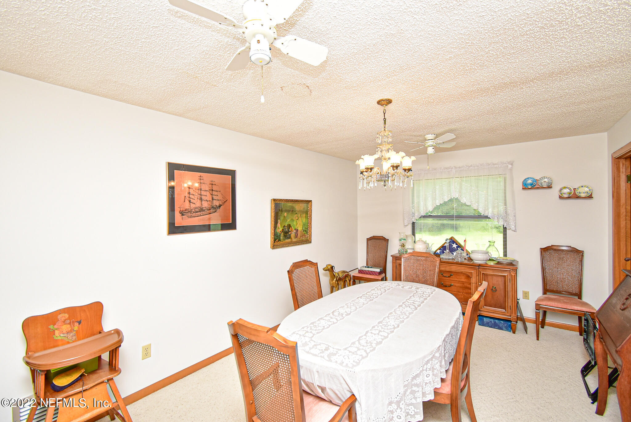 105 Tallow Road Pomona Park, FL 32181 - Photo 27 of 55 a view of a dining room with furniture and a chandelier