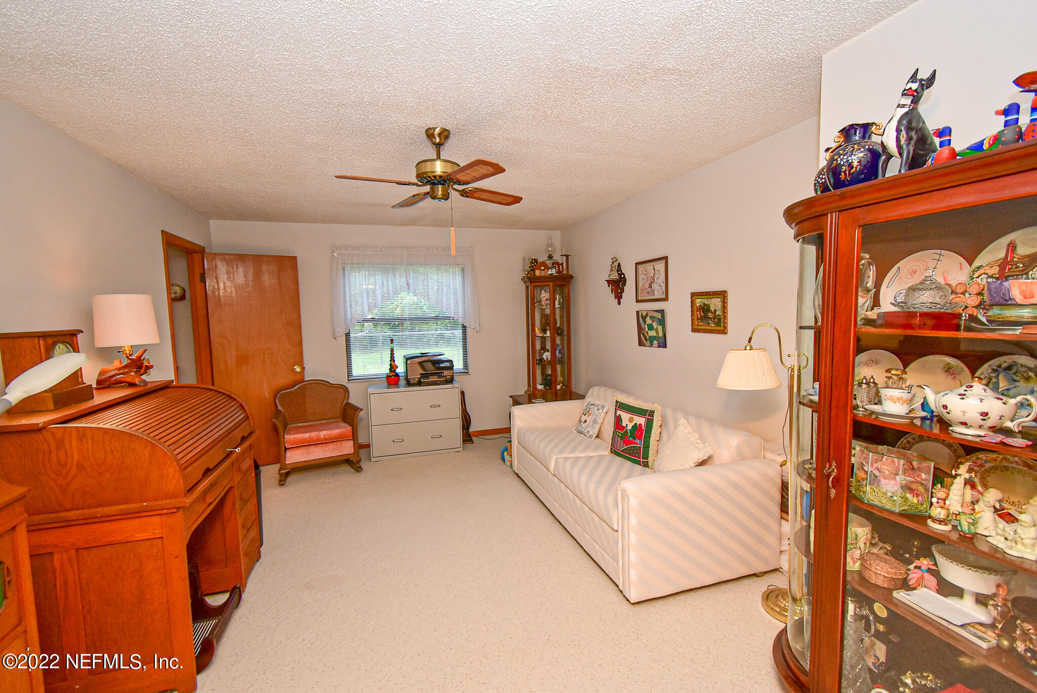 105 Tallow Road Pomona Park, FL 32181 - Photo 29 of 55 a living room with furniture and a flat screen tv