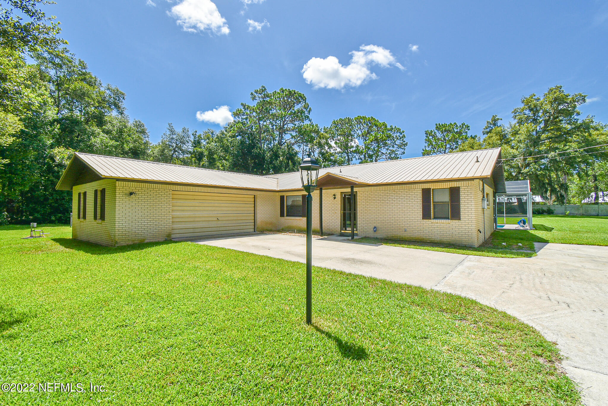105 Tallow Road Pomona Park, FL 32181 - Photo 3 of 55 a view of a house with backyard and a garden