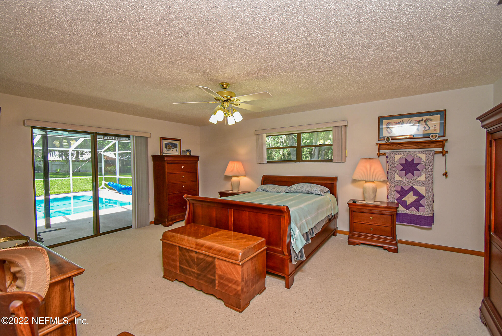 105 Tallow Road Pomona Park, FL 32181 - Photo 33 of 55 a bed room with a bed and a chandelier
