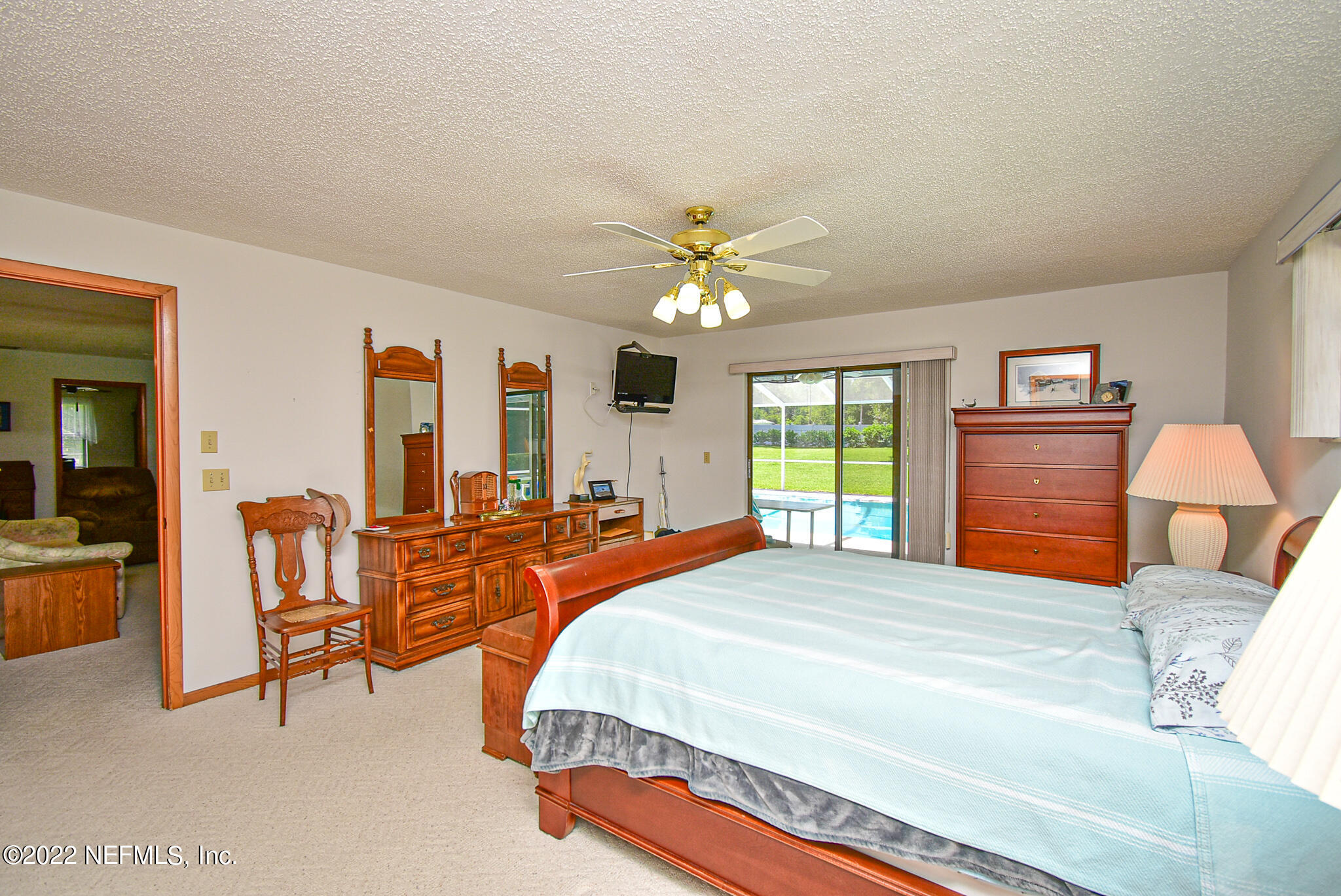 105 Tallow Road Pomona Park, FL 32181 - Photo 34 of 55 a bedroom with a bed and a chandelier