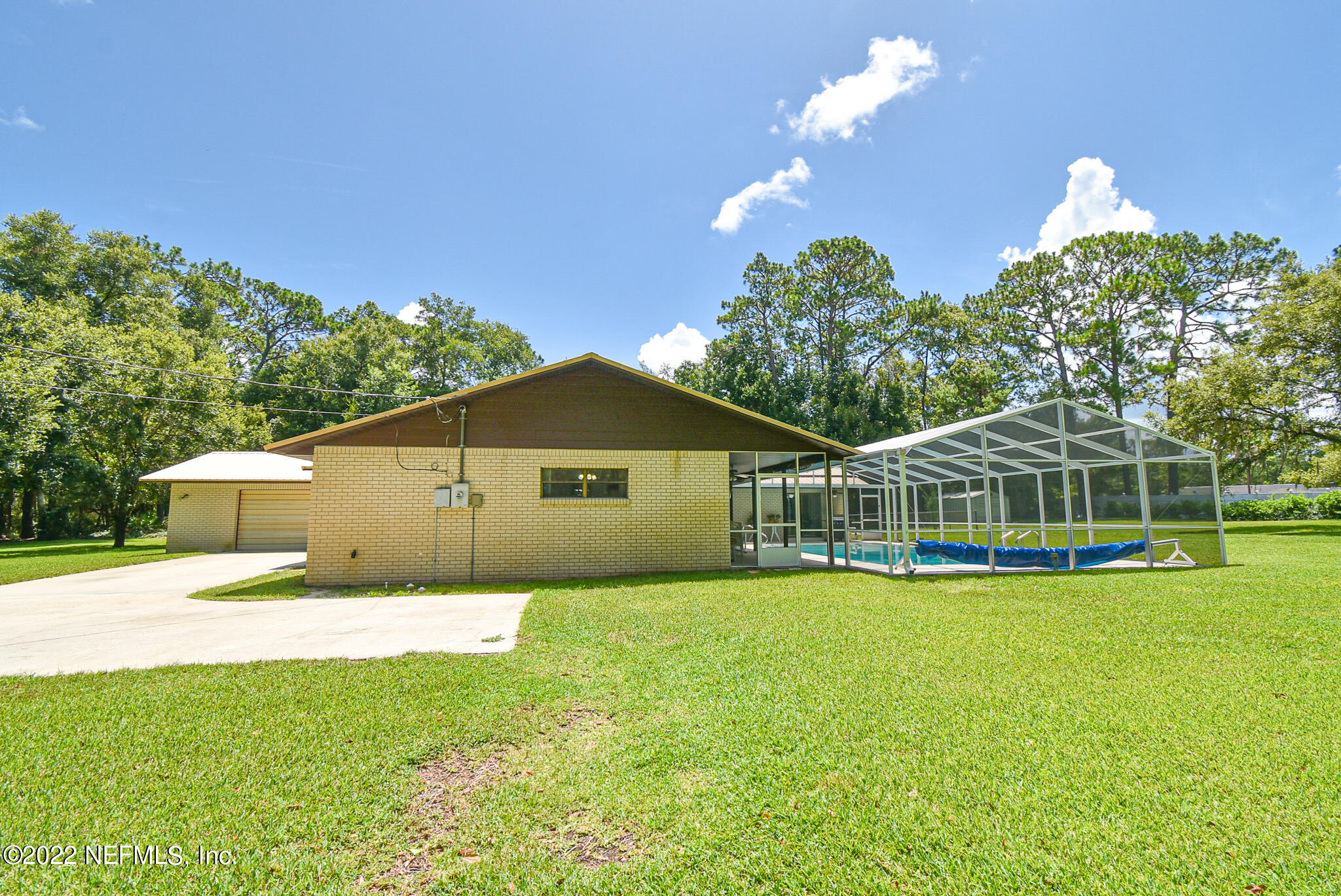 105 Tallow Road Pomona Park, FL 32181 - Photo 44 of 55 a front view of a house with a yard and trees