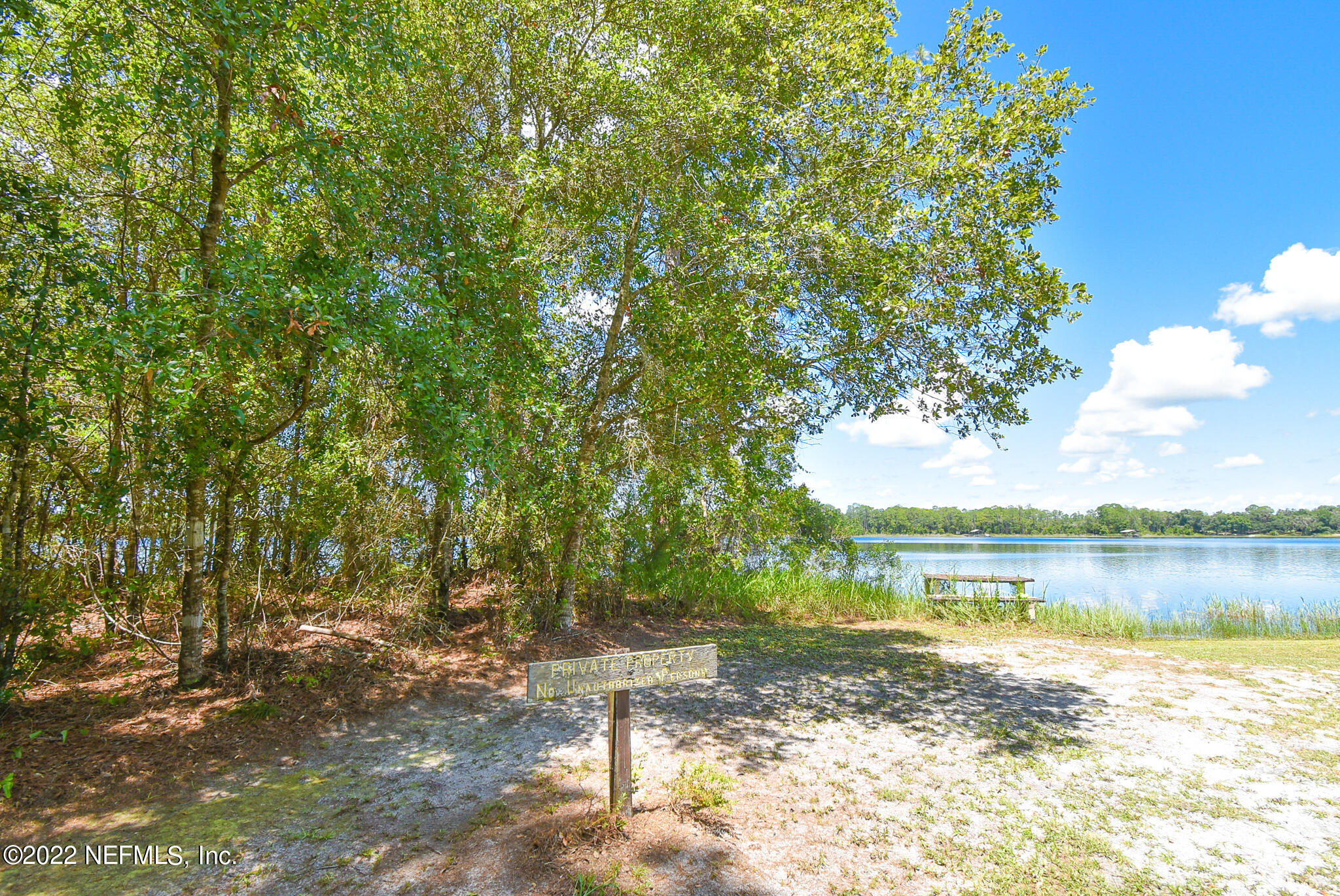 105 Tallow Road Pomona Park, FL 32181 - Photo 5 of 55 a view of a lake with a big yard