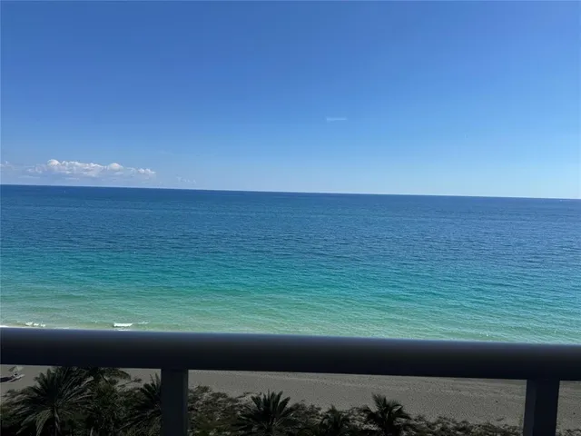 a view of a balcony with an outdoor seating