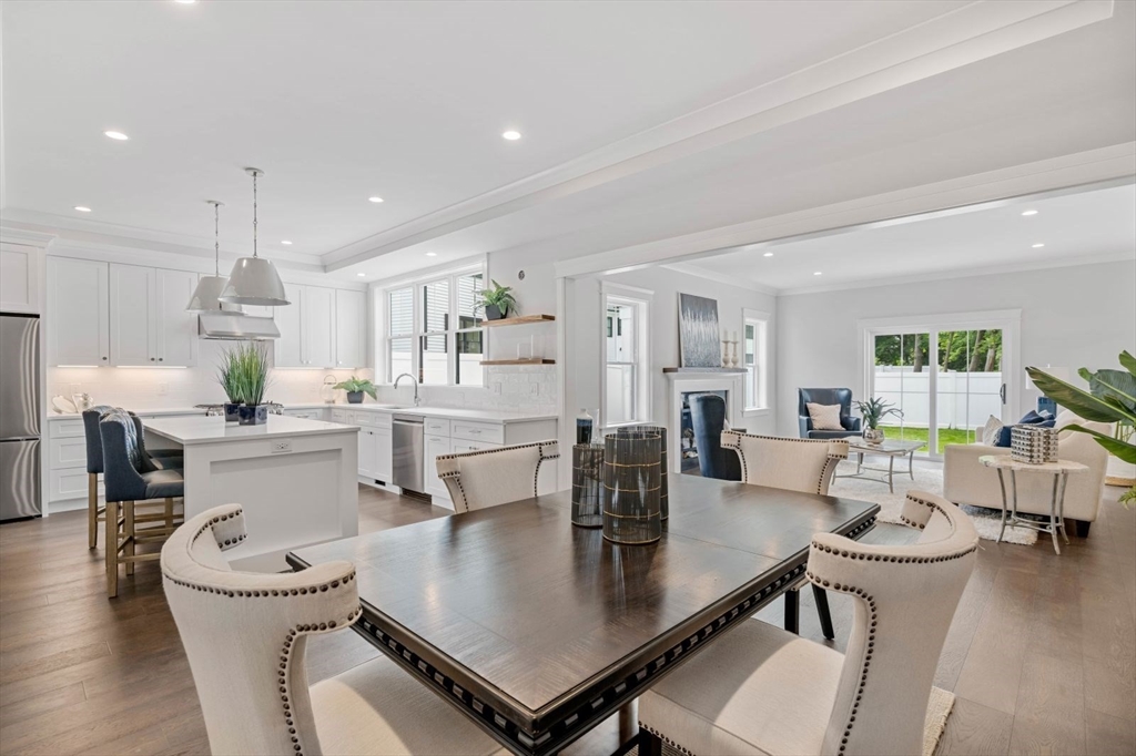 a kitchen with a table chairs and white cabinets