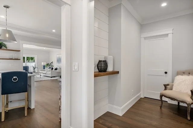 a view of a hallway and dining room with wooden floor