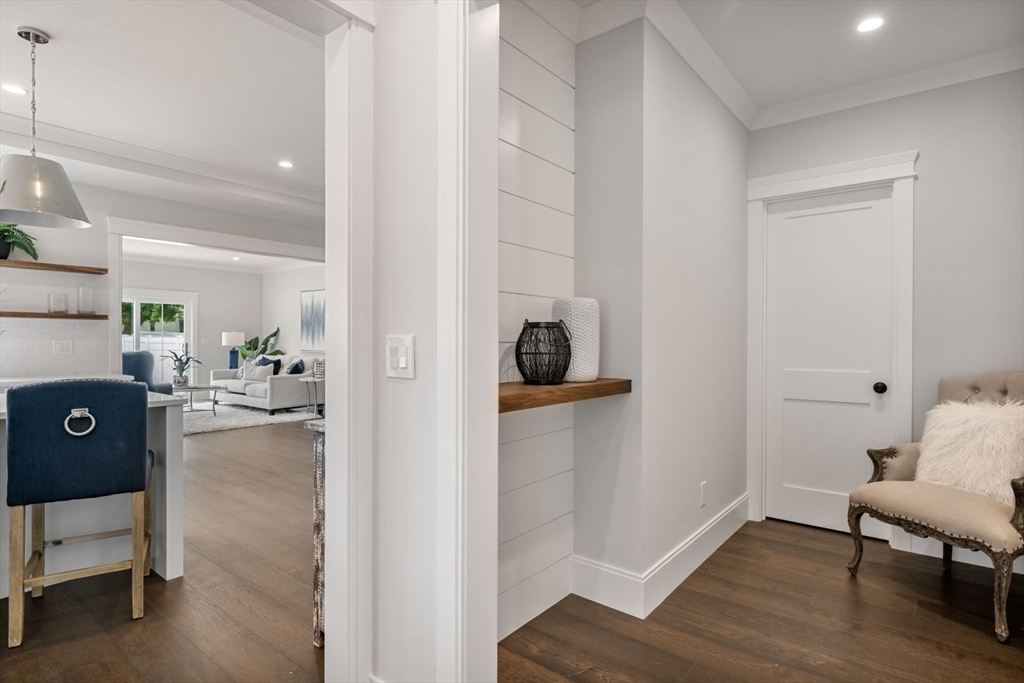 5 Milk Street Natick, MA 01760 - Photo 12 of 36 a view of a hallway and dining room with wooden floor