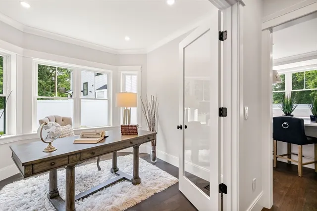 a view of a workspace with furniture and a window