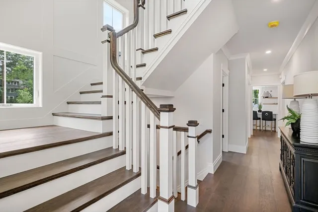 a view of entryway and hall with wooden floor