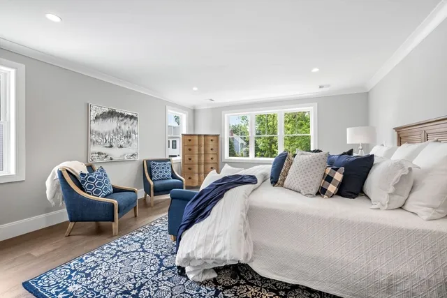 a bed room with a bed and a chair