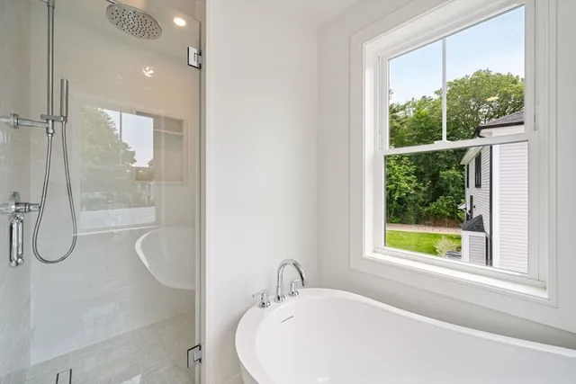 a bathroom with a bath tub and a window