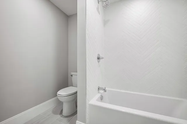 a bathroom with a toilet and a tub