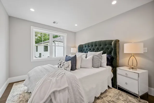 a bed room with a bed and a night stand