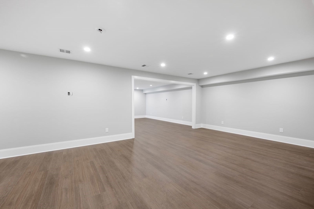 5 Milk Street Natick, MA 01760 - Photo 33 of 36 a view of an empty room with wooden floor