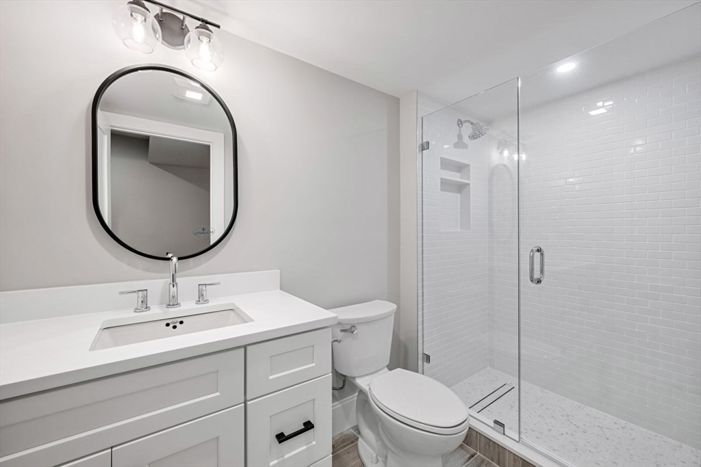 5 Milk Street Natick, MA 01760 - Photo 34 of 36 a bathroom with a toilet a sink and mirror