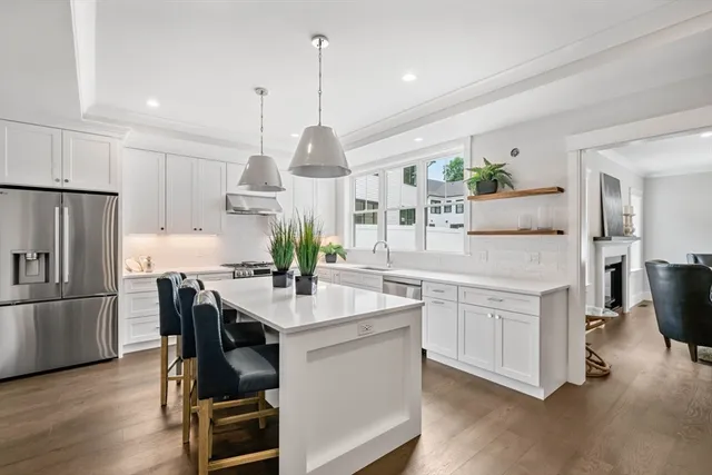 a kitchen with kitchen island a counter top space appliances and cabinets