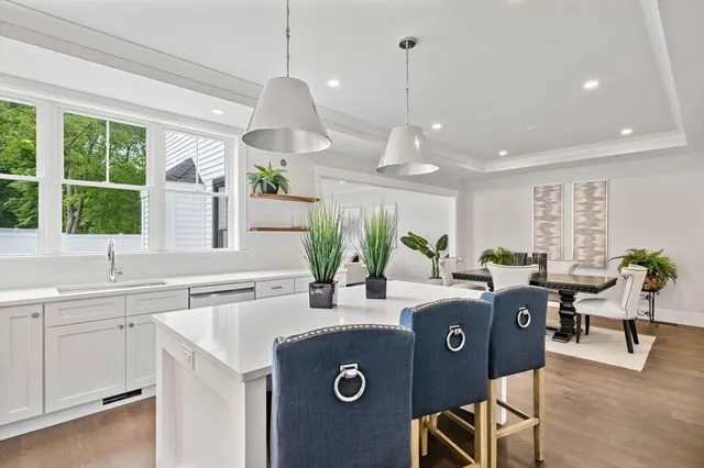 a view of a kitchen with kitchen island granite countertop furniture and a large window
