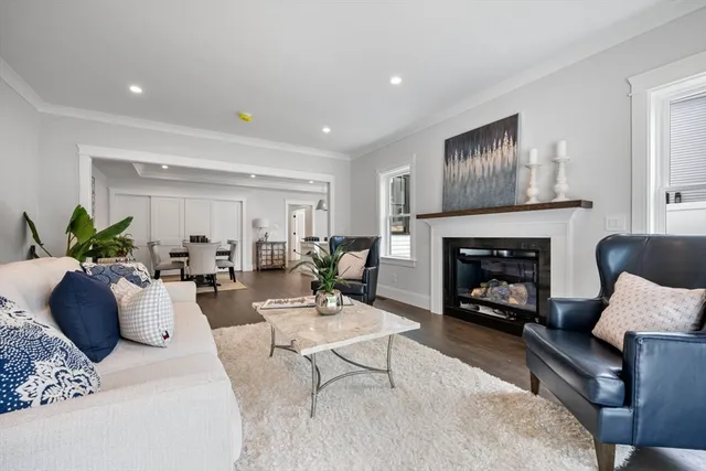 a living room with furniture fireplace and window