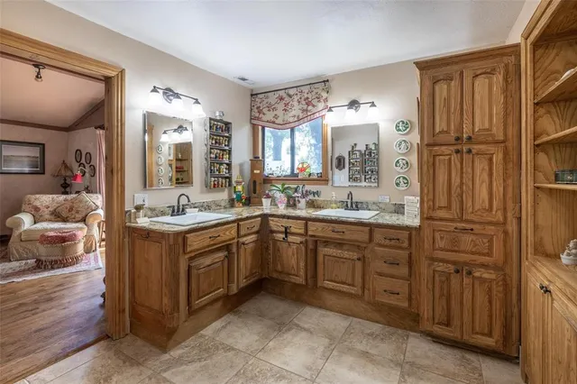 a spacious bathroom with a granite countertop sink mirror and a