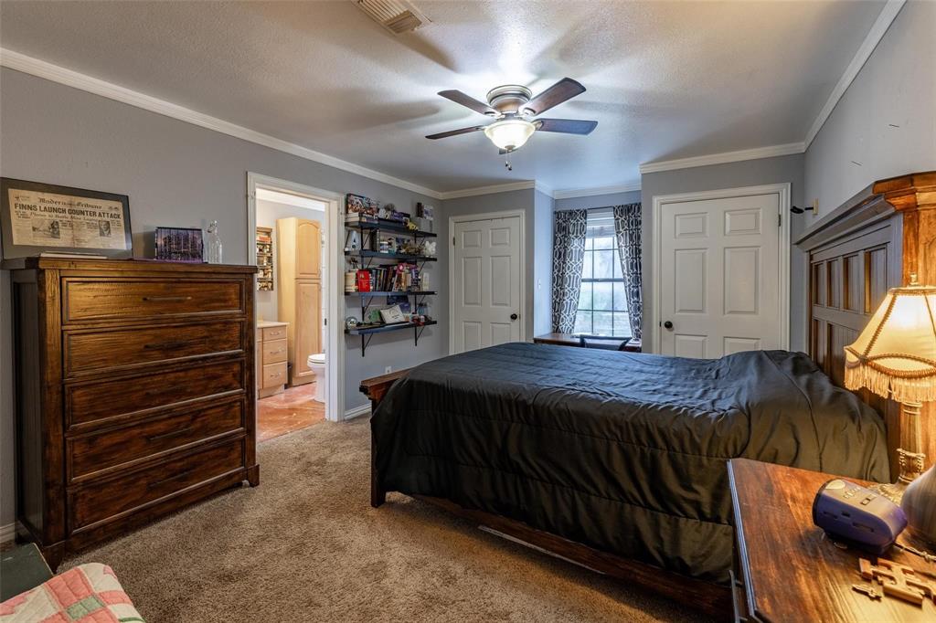 13360 Miller Road Azle, TX 76020 - Photo 17 of 19 a bed room with a bed and a chandelier