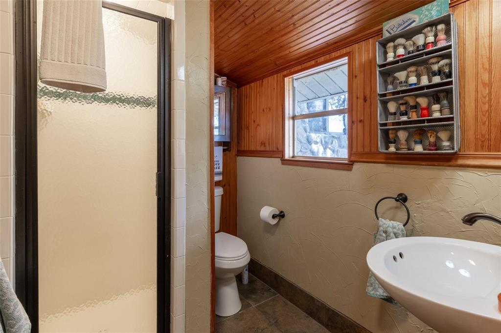 13360 Miller Road Azle, TX 76020 - Photo 7 of 19 a bathroom with a sink a toilet and shower