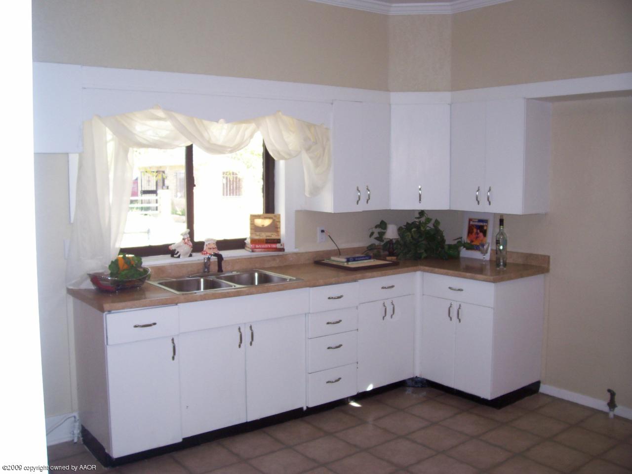 3901 South Polk Street Amarillo, TX 79110 - Photo 1 of 8 a kitchen with granite countertop white cabinets and a sink