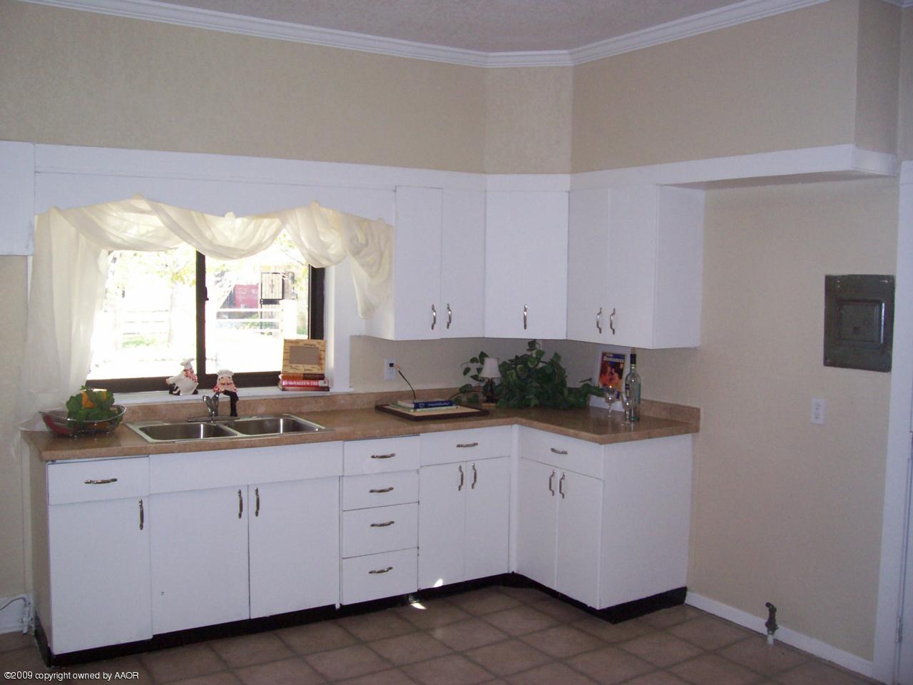 3901 South Polk Street Amarillo, TX 79110 - Photo 2 of 8 a kitchen with white cabinets and sink