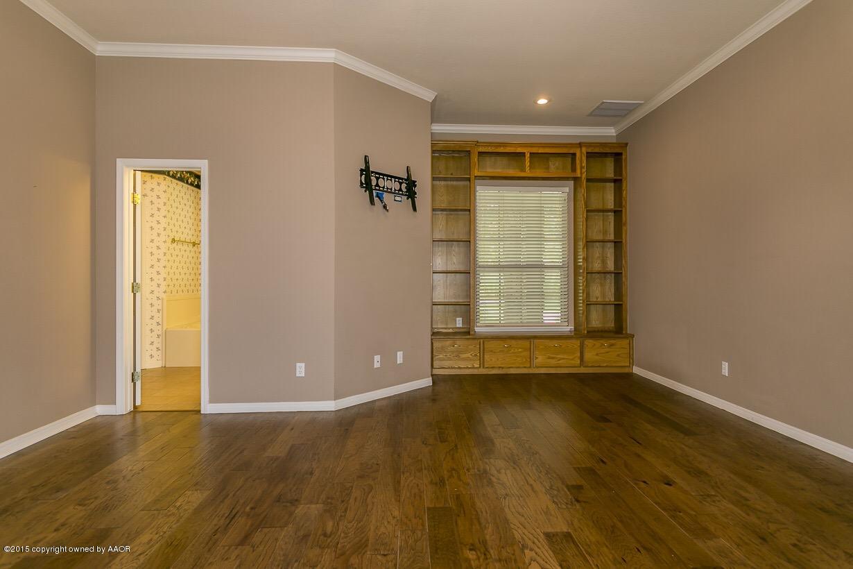 525 Fox Ridge Road Amarillo, TX 79118 - Photo 17 of 29 a view of an empty room with wooden floor and a window