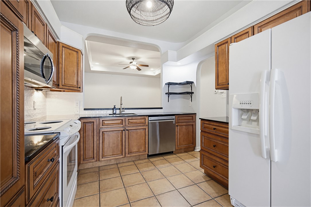 7251 Prairie Drive, Unit 6 Corpus Christi, TX 78413 - Photo 8 of 28 a kitchen with stainless steel appliances granite countertop a refrigerator and a stove top oven