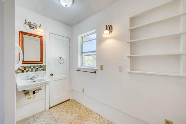 a room with a cabinets and window