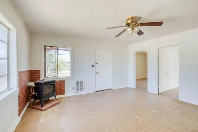 a view of room with workspace and windows