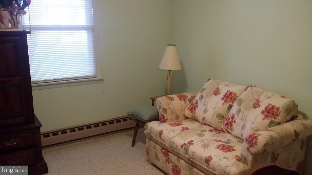 18 A Sycamore Access Road, Unit 5B Manahawkin, NJ 08050 - Photo 11 of 19 a bed sitting in a bedroom next to a window