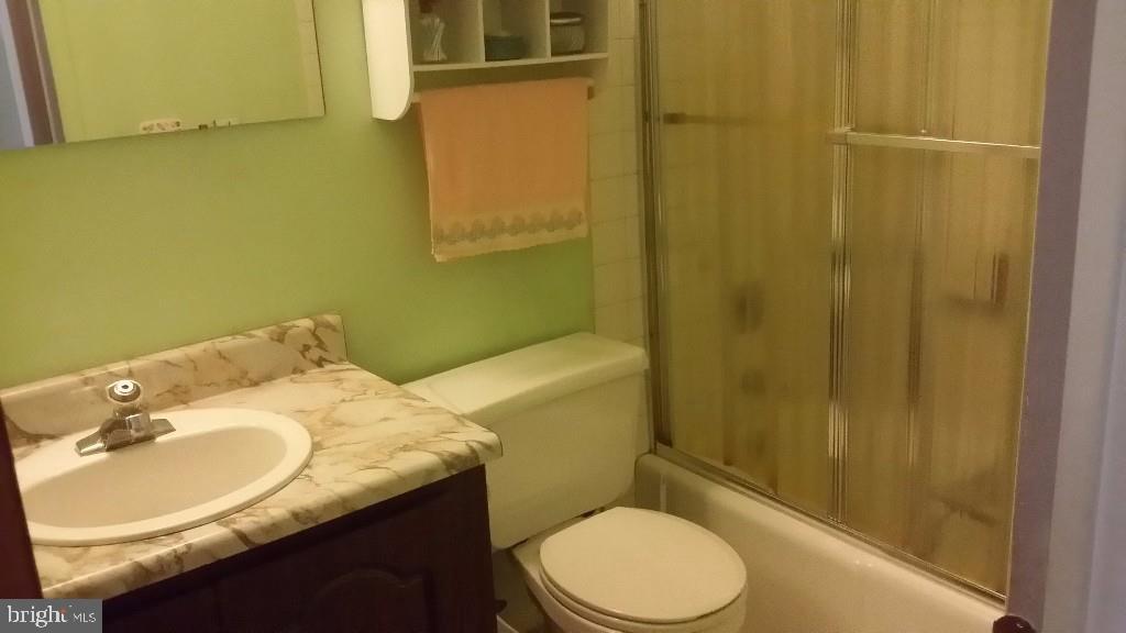 18 A Sycamore Access Road, Unit 5B Manahawkin, NJ 08050 - Photo 14 of 19 a bathroom with a granite countertop sink toilet and shower