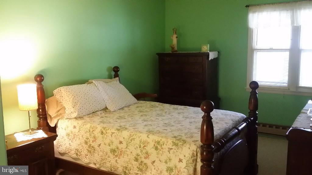 18 A Sycamore Access Road, Unit 5B Manahawkin, NJ 08050 - Photo 16 of 19 a bedroom with a bed dresser and a window