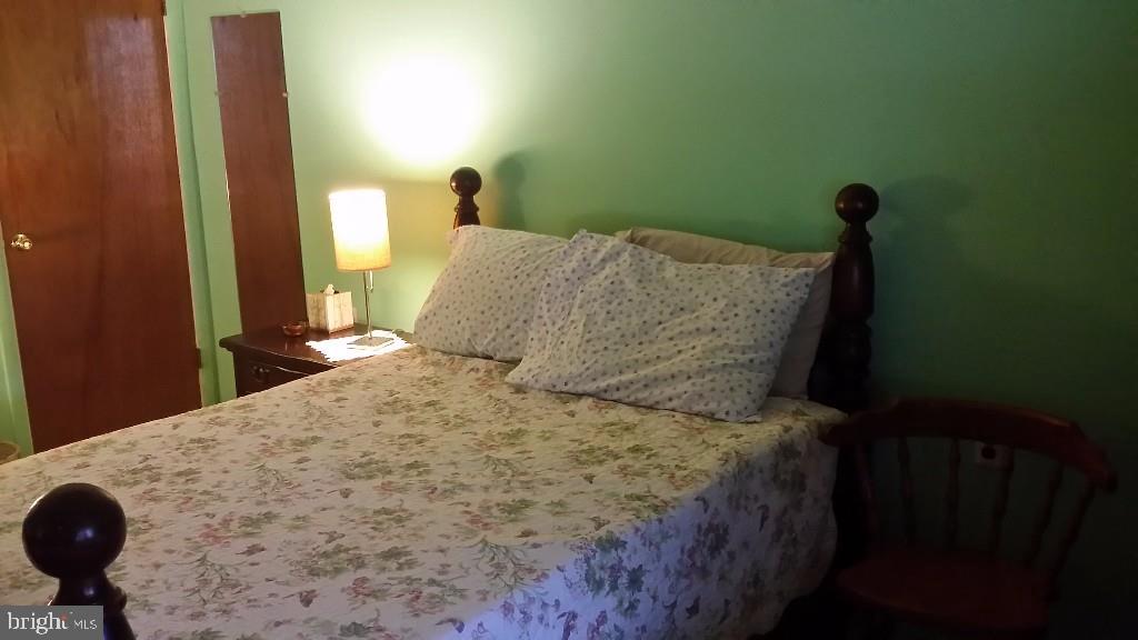 18 A Sycamore Access Road, Unit 5B Manahawkin, NJ 08050 - Photo 18 of 19 a bedroom with a bed and a lamp on dresser