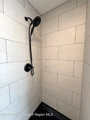 a utility room with a sink a mirror and next to a window