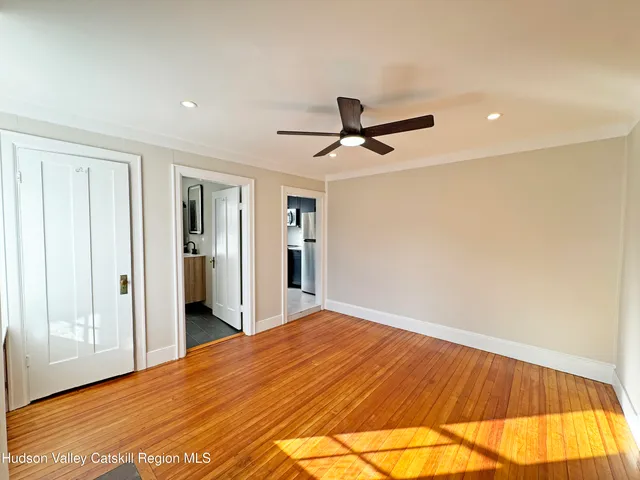 a view of a hallway with wooden floor