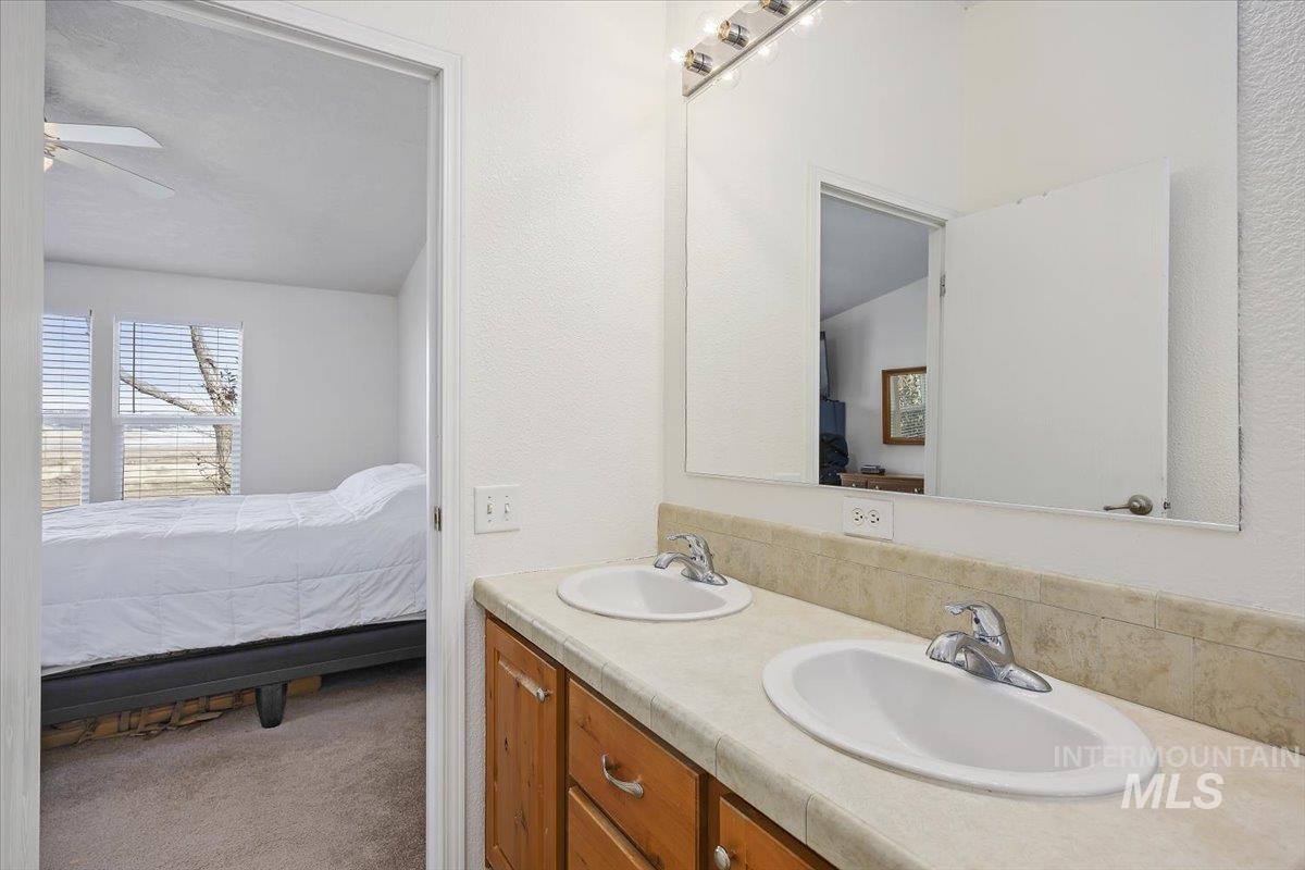 1014 S Highway Albion, ID 83311 - Photo 20 of 34 Ensuite bathroom featuring double vanity, carpet floors, a textured wall, and ceiling fan