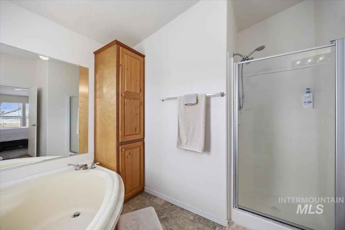 1014 S Highway Albion, ID 83311 - Photo 22 of 34 Ensuite bathroom featuring a shower stall and a garden tub