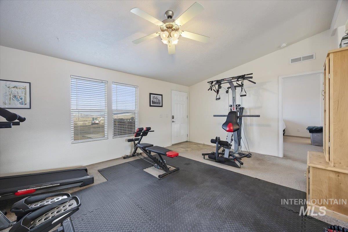 1014 S Highway Albion, ID 83311 - Photo 5 of 34 Exercise room with lofted ceiling, carpet flooring, and a ceiling fan