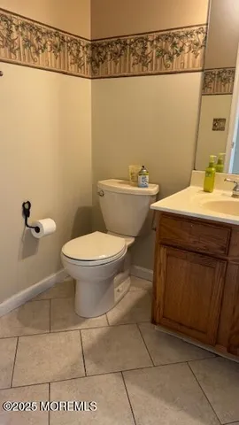 a bathroom with a sink a toilet and mirror