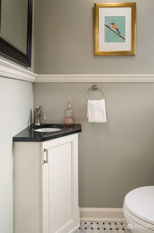 a bathroom with a sink a toilet and vanity